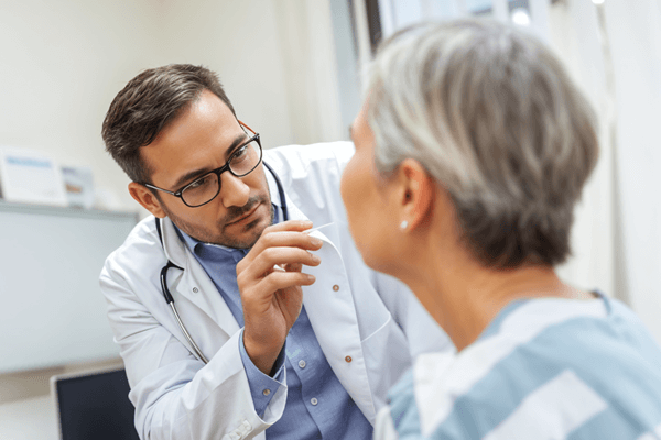 Elderly patient getting a saliva swab